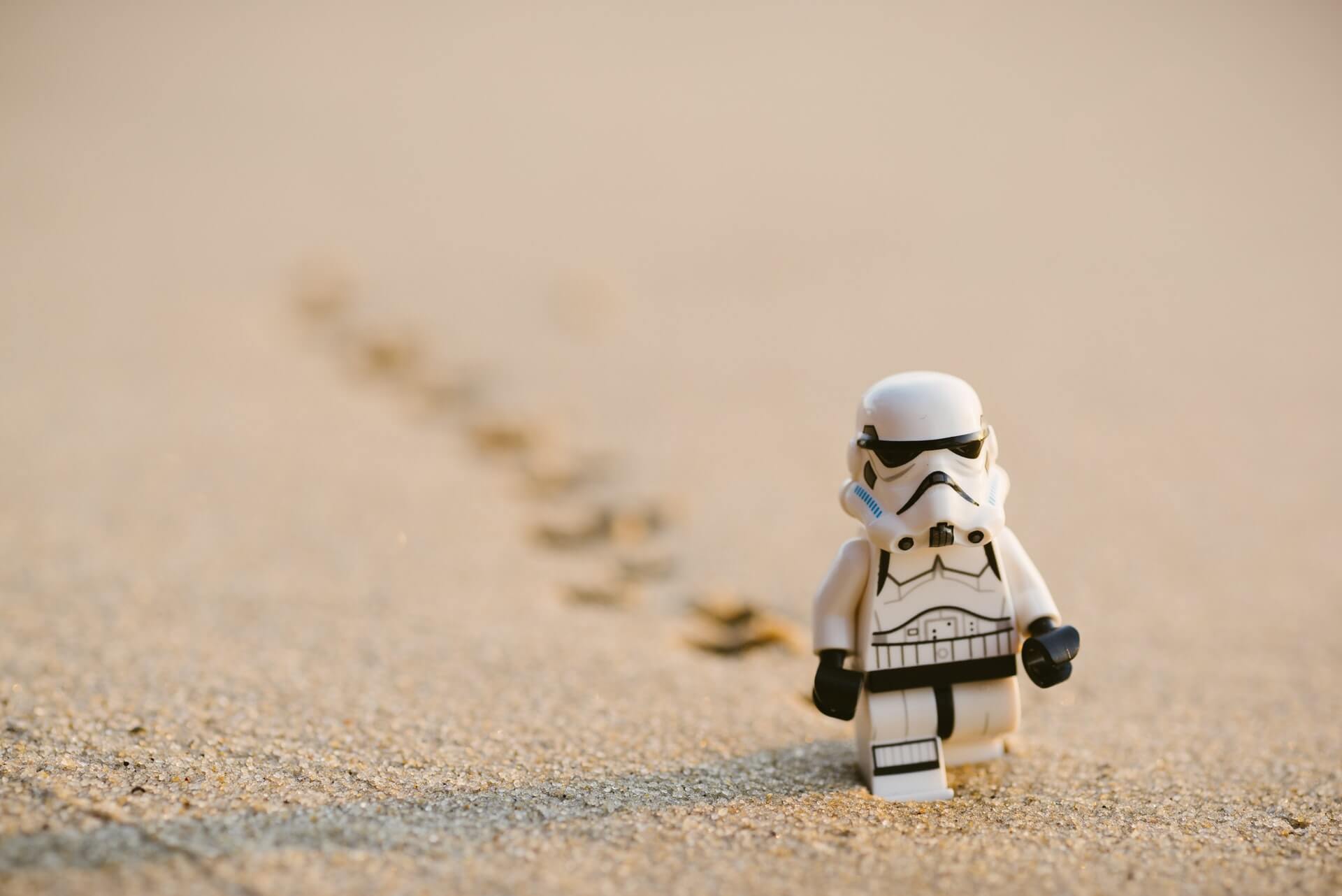 Stormtrooper walking on sand by Daniel Cheung on Unsplash